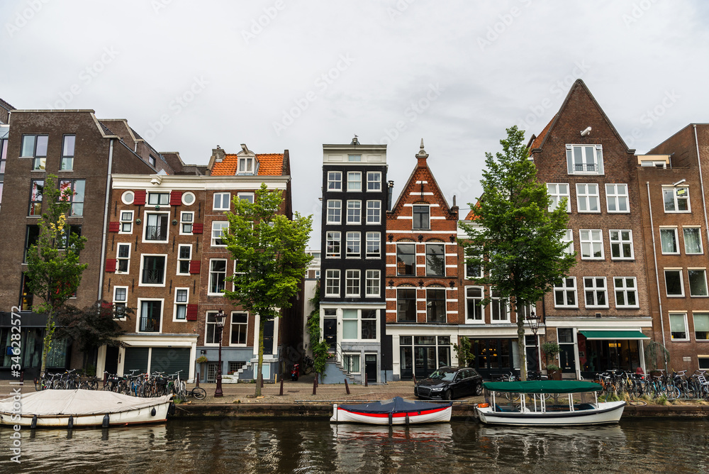 Water canals and traditional Dutch architecture colorful houses in Amsterdam, Netherlands