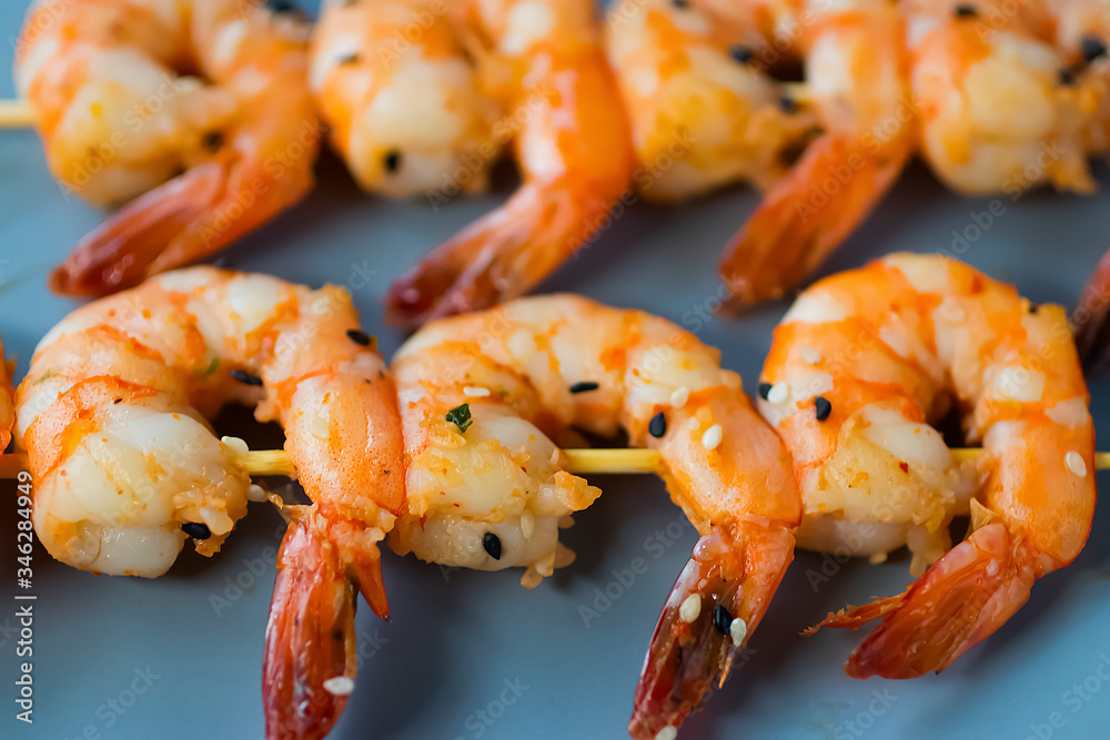 Yakitori kebabs with shrimp on a gray plate. Soft focus. Yakitori kebabs with shrimp on a gray plate. Soft focus.