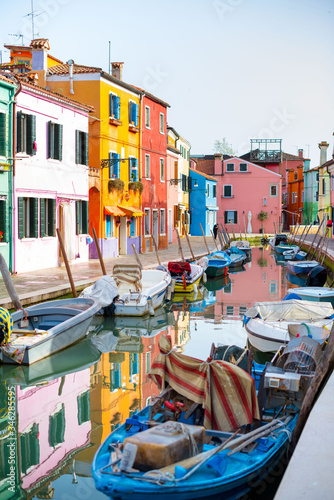 Burano island. Beautiful colored houses, canal with boats. beautiful sunny day in the city