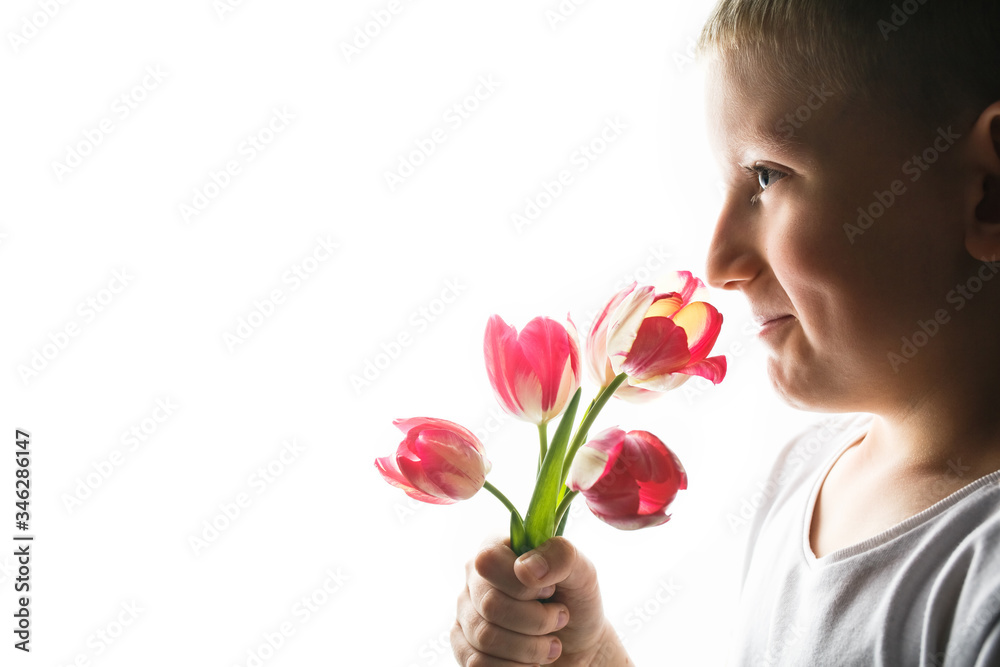 Boy with bouquet of tulips on isolated background Boy with bouquet of tulips on isolated background