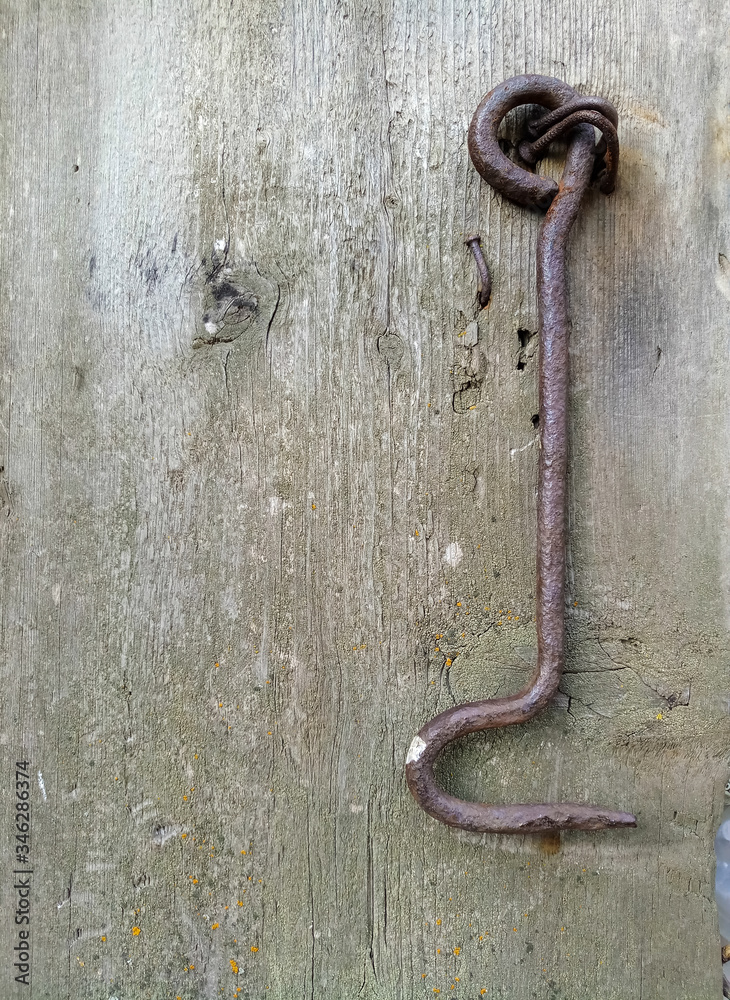 Obraz premium texture of old painted shabby rustic wooden fence made of planks, with rusty nails, hand-forged iron elements, grunge background