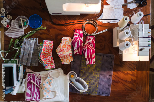 Overhead view of sewing machine and masks on table