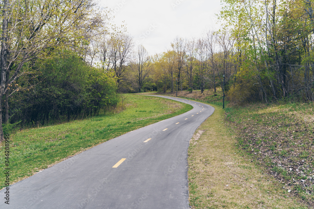 Peaceful paved walking and biking trail through Elm Creek Park Reserve in Maple Grove Minnesota