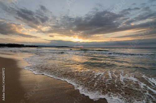 Beautiful morning landscape of the Black Sea coast of Bulgaria with waves at sunrise.