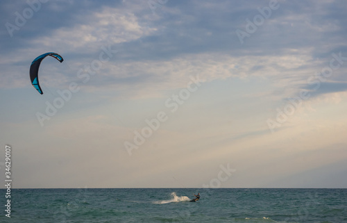 kitesurfer rides a kite-surf on waves of the sea