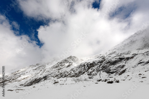 Beautiful winter landscape. The tops of the mountains in the snow against the blue sky