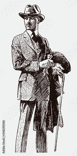 Gentleman from early 20th century, putting on gloves, wearing suit and hat, holding coat and walking stick