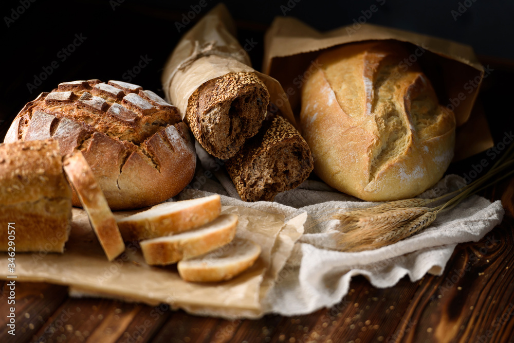Various freshly baked bread on a wooden rustic table
