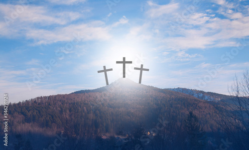 Resurrection. Crucifixion against the sky. Wooden cross on the mountain. The symbol of death. Atonement for Sins