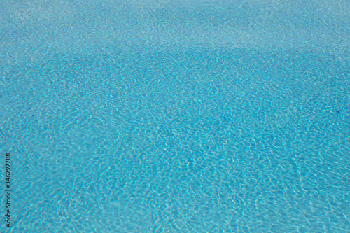 Blue and crystalline water of a swimming pool