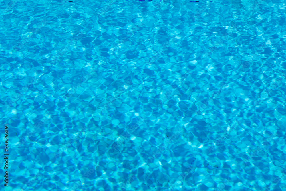 Blue and crystalline water of a swimming pool