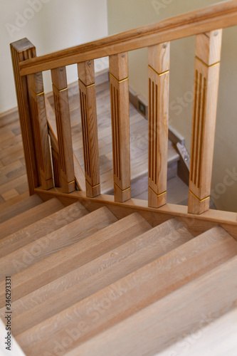 Detail of the wooden interior staircase in the house. Selective focus. Low DOF