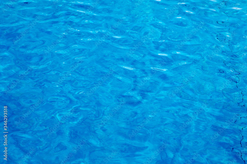 Blue and crystalline water of a swimming pool