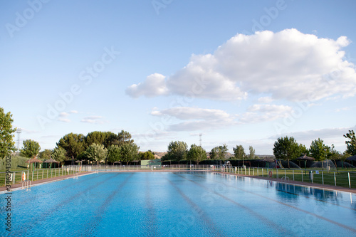 Sunny swimming pool with blue water