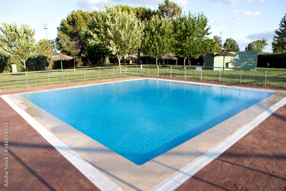 Sunny swimming pool with blue water