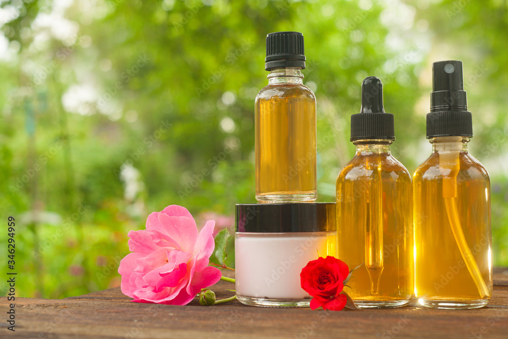 Essence of rose on table in beautiful glass bottle Essence of rose on table in beautiful glass bottle