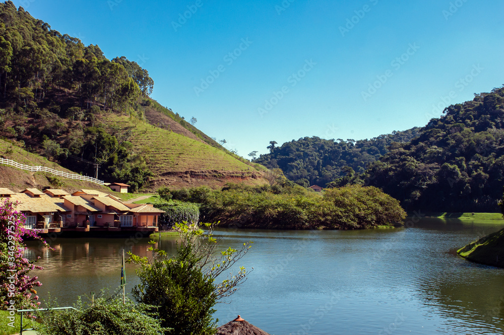 Large dark water lake, with houses and lots of forest around, Barra do Pirai, Rio de Janeiro, Brazil