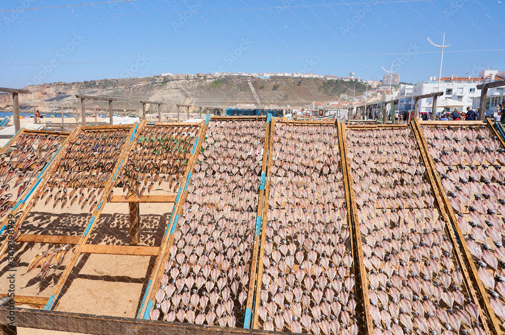 Fototapeta premium Fish drying at the sun on beach of Nazaré