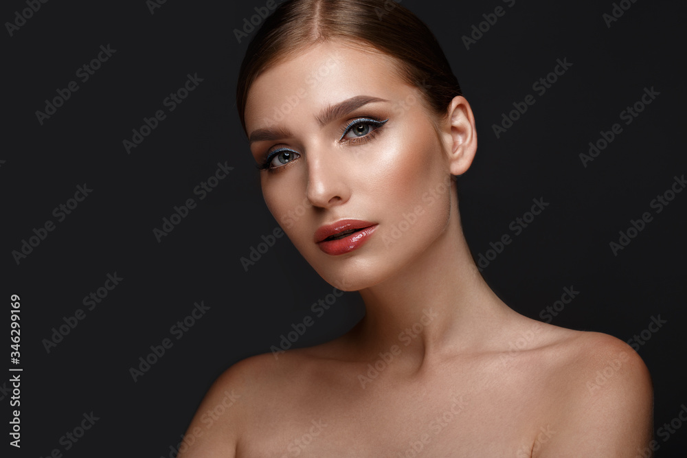 Beautiful girl with sexy lips and classic makeup with cosmetic blue eyeliner . Beauty face.