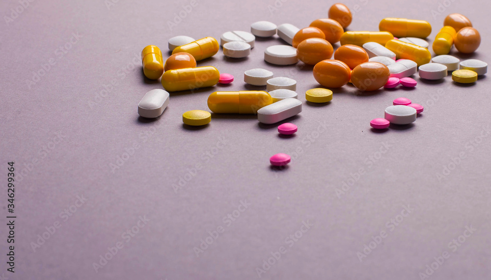 Pile of various colorful pills isolated on gray Pile of various colorful pills isolated on gray