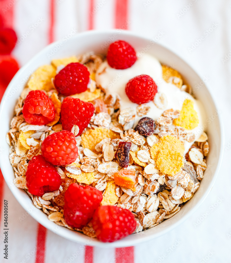 Delicious breakfast. With oat flakes, dried fruit and yogurt on a blue background. Delicious breakfast. With oat flakes, dried fruit and yogurt on a blue background.