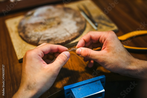 Master goldsmith working at golden ring. Jewelry, craft, handmade industry concept .