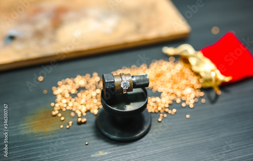Gold granules and ring made by the jewelry master .