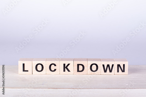 wooden cubes building the word Lockdown, white background