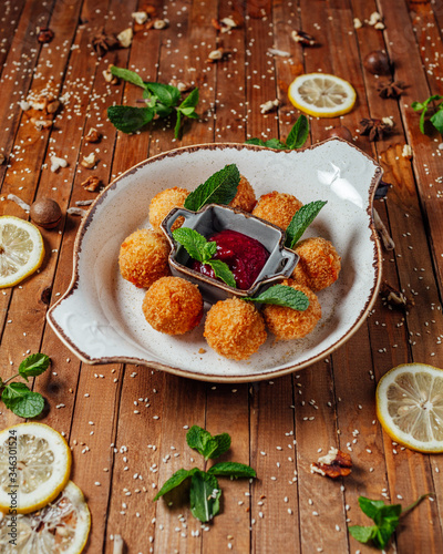 cheese balls on a plate with sauce