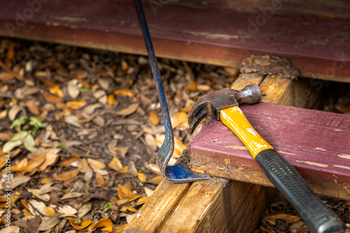 Flat pry bar and a claw hammer on a deck construction photo