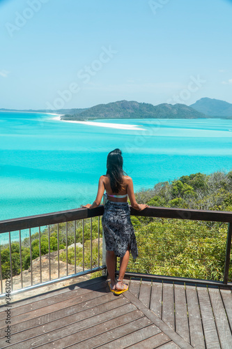 Woman Tourist at beach ocean view,. Whitehaven Whitsundays. Turquoise ocean, white sand. Dramatic DRONE view from above. Travel, holiday, vacation, paradise. Shot in Hill Inlet, Queenstown, Australia. © Jam Travels
