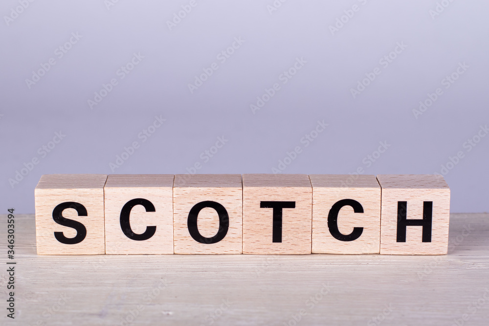 wooden cubes building the word Scotch,white background wooden cubes building the word Scotch,white background