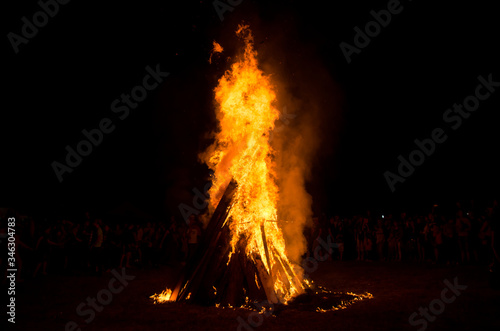 Huge bonfire at night. The Slavic holiday of Ivan Kupala. Round dance around the fire