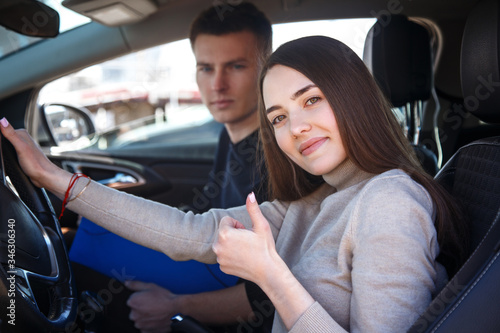 Driving instructor and woman student in examination car.