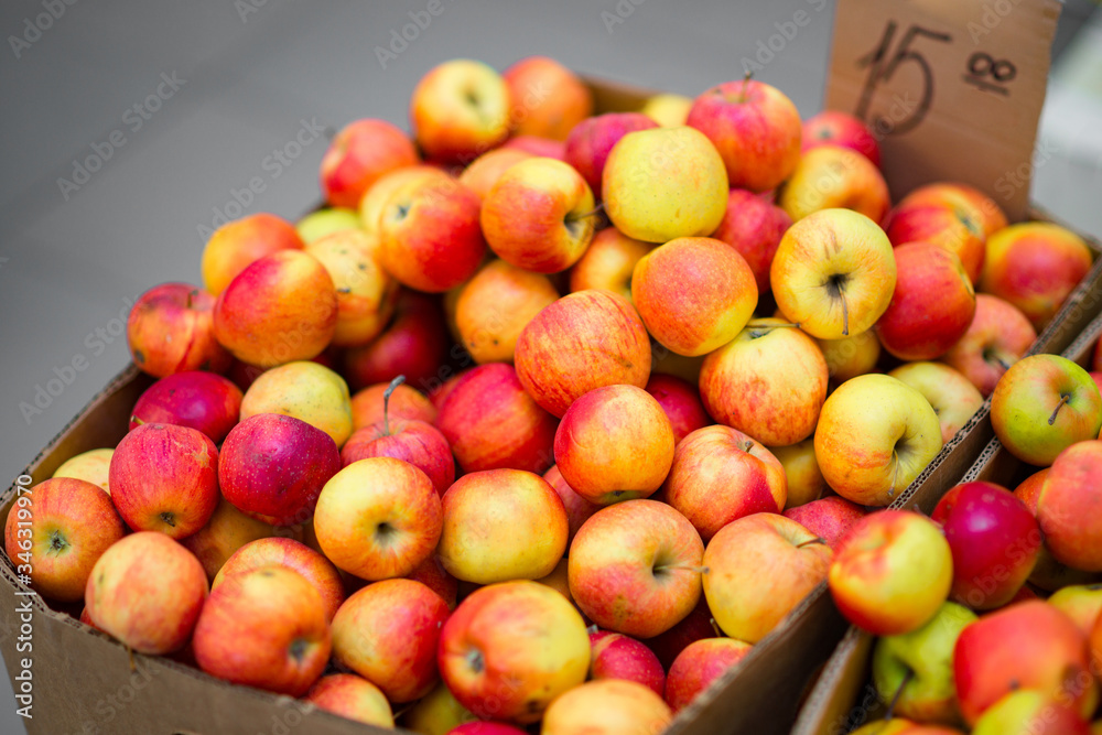 Fresh organic rows of apples crates at the farmers market.