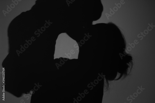 Silhouette Of Happy Mother and Baby. Mom kissing baby, Happy Mother's Day concept