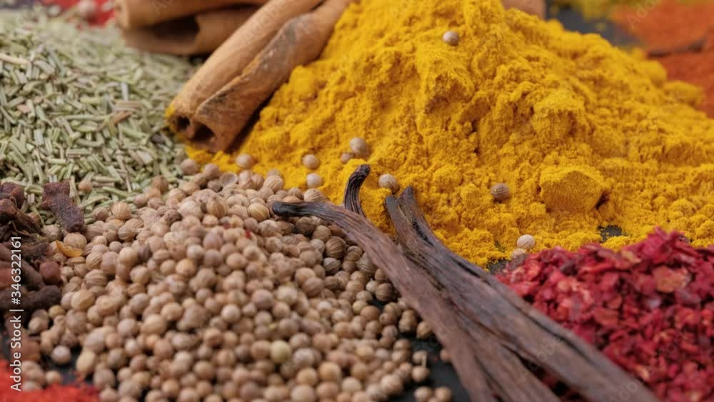 Various fragrant spice market. Heap different Indian Spices rotated on wooden table. Assortment spices and herbs for cooking