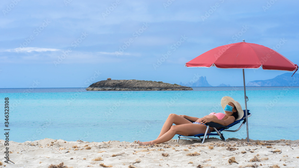 Pandemic tourism. Girl with mask on the beach. Pandemic tourism. Girl with mask on the beach.