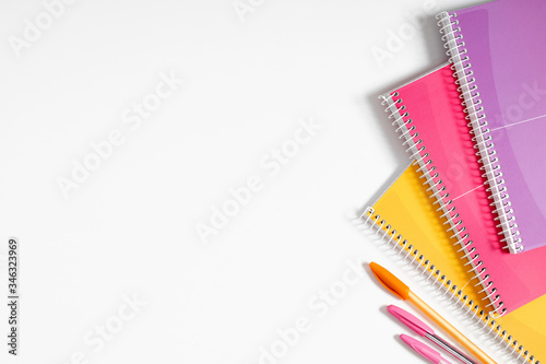 Creative minimalistic school or office supplies, notebook, pen on white background. Education concept. Flat lay, top view, copy space