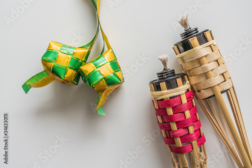 Ketupat decoration and Bamboo lamp or pelita buluh over white background. Eid mubarak festival photo