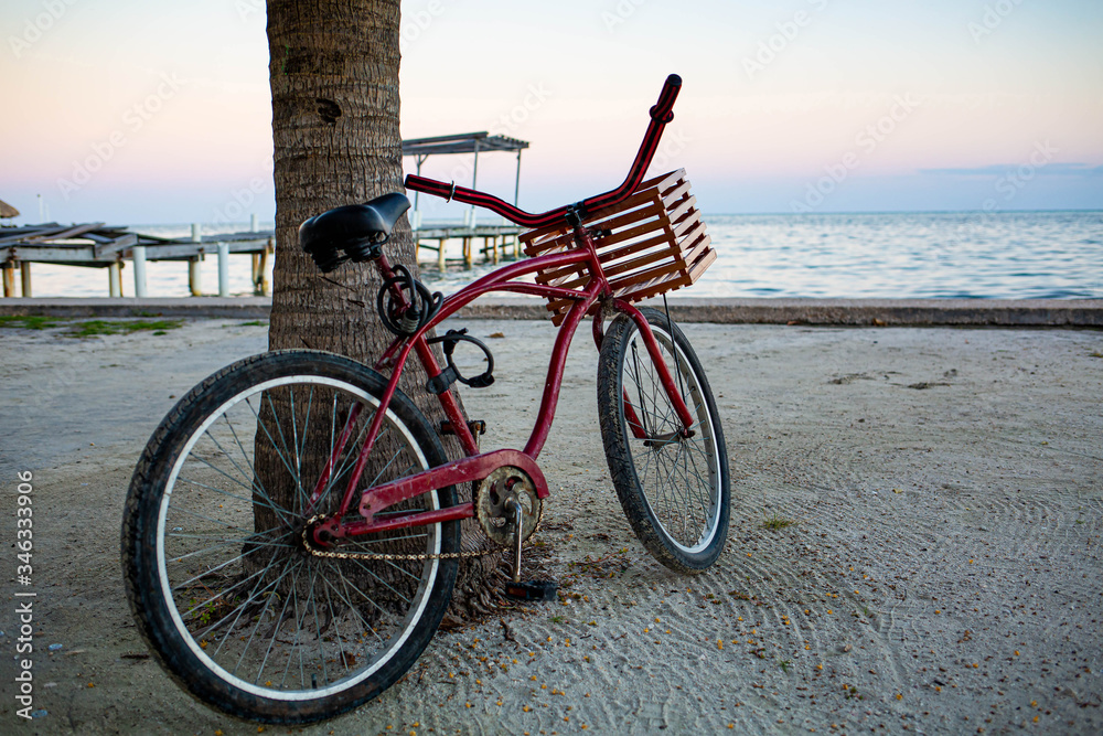 Red bike at the seashore with nobody ready to ride