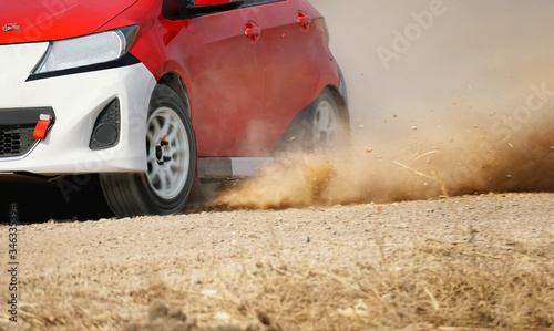 Rally racing car on dirt road.