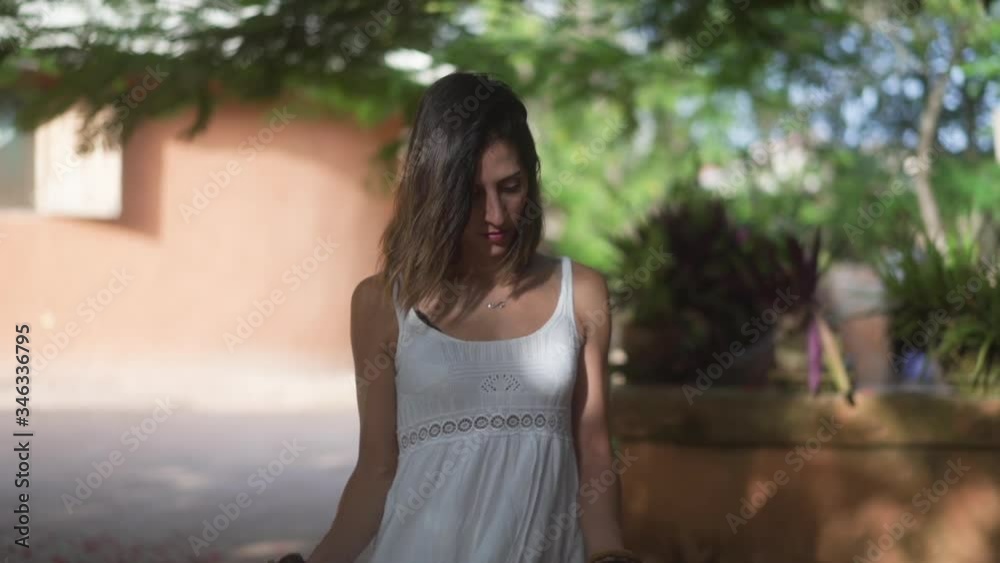 happy woman dancing outdoors and holding her white dress happy woman dancing outdoors and holding her white dress