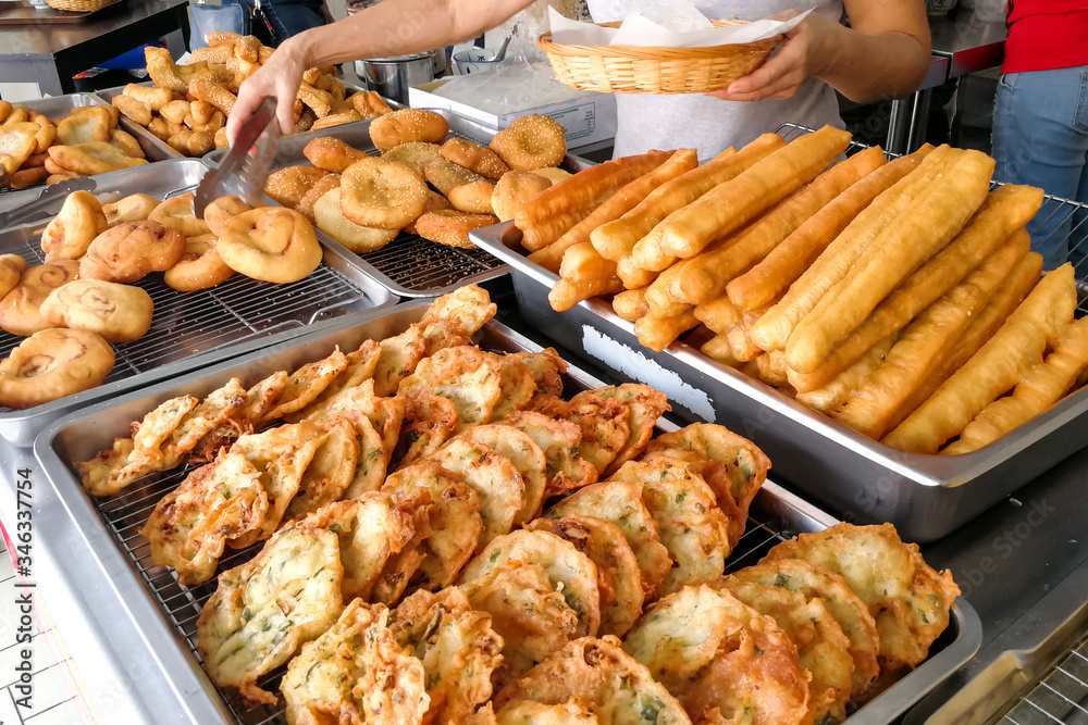 Various types of fried bread sticks or you tiao at hawker stall