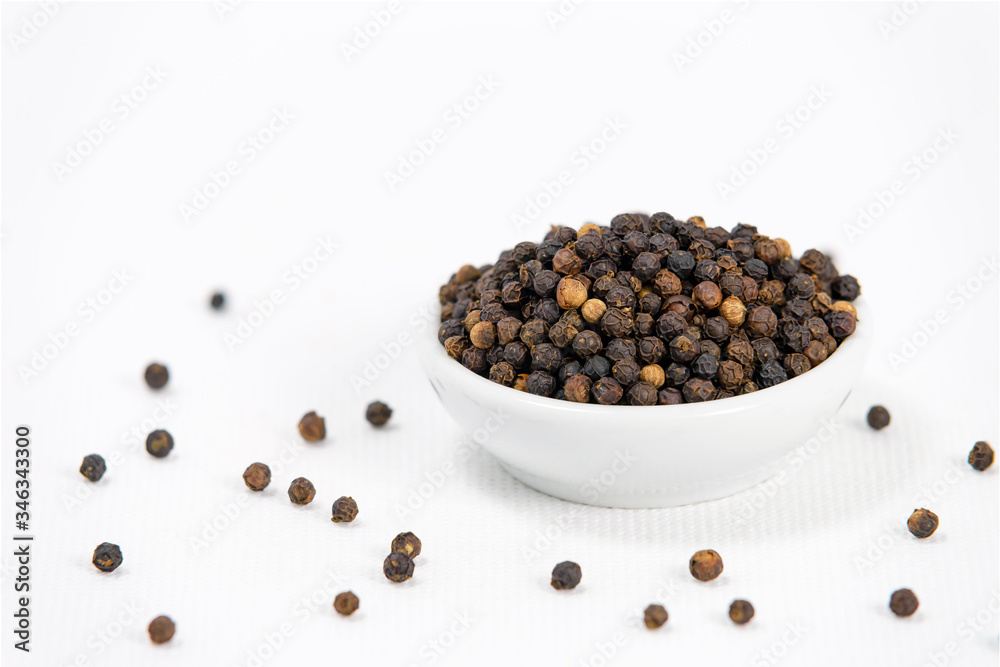 black pepper in white bowl on white canvas background black pepper in white bowl on white canvas background