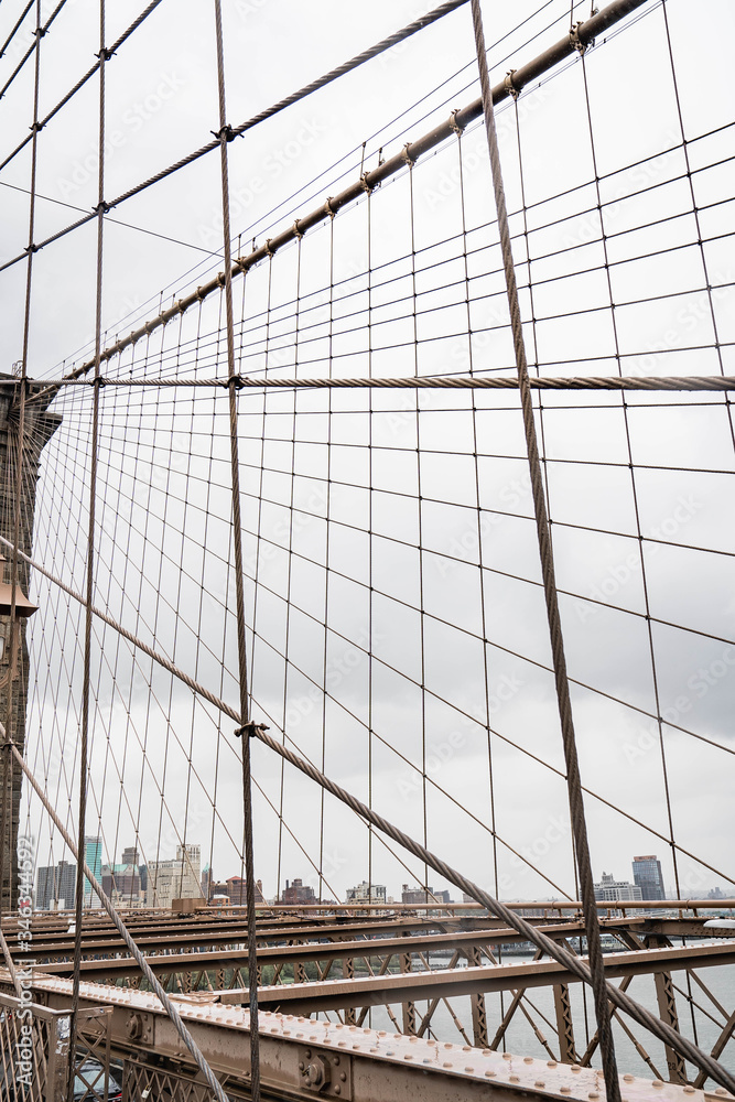 Fototapeta premium Brooklyn bridge. Rainy Brooklyn bridge view. Brooklyn bridge close up view. Rainy day at Brooklyn bridge. 
