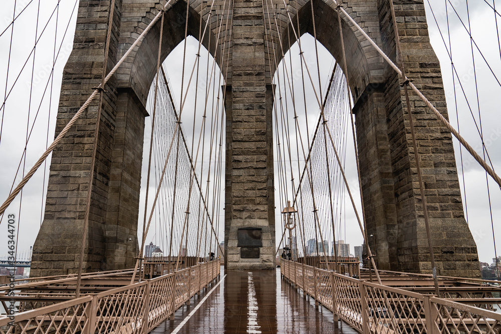 Naklejka premium Brooklyn bridge. Rainy Brooklyn bridge view. Brooklyn bridge close up view. Rainy day at Brooklyn bridge. 
