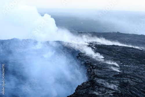 Gases and steam rise from the Kilauea Caldera at dawn