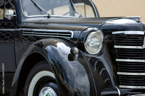 Old black soviet retro and vintage car close-up without logo, soft and selective focus.