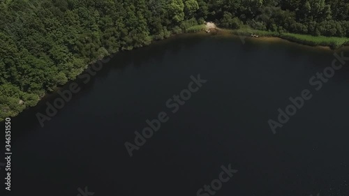 Drone flying above beautiful lakes created due to sandmining to build a highway with different applications like nature reserve and recreation photo